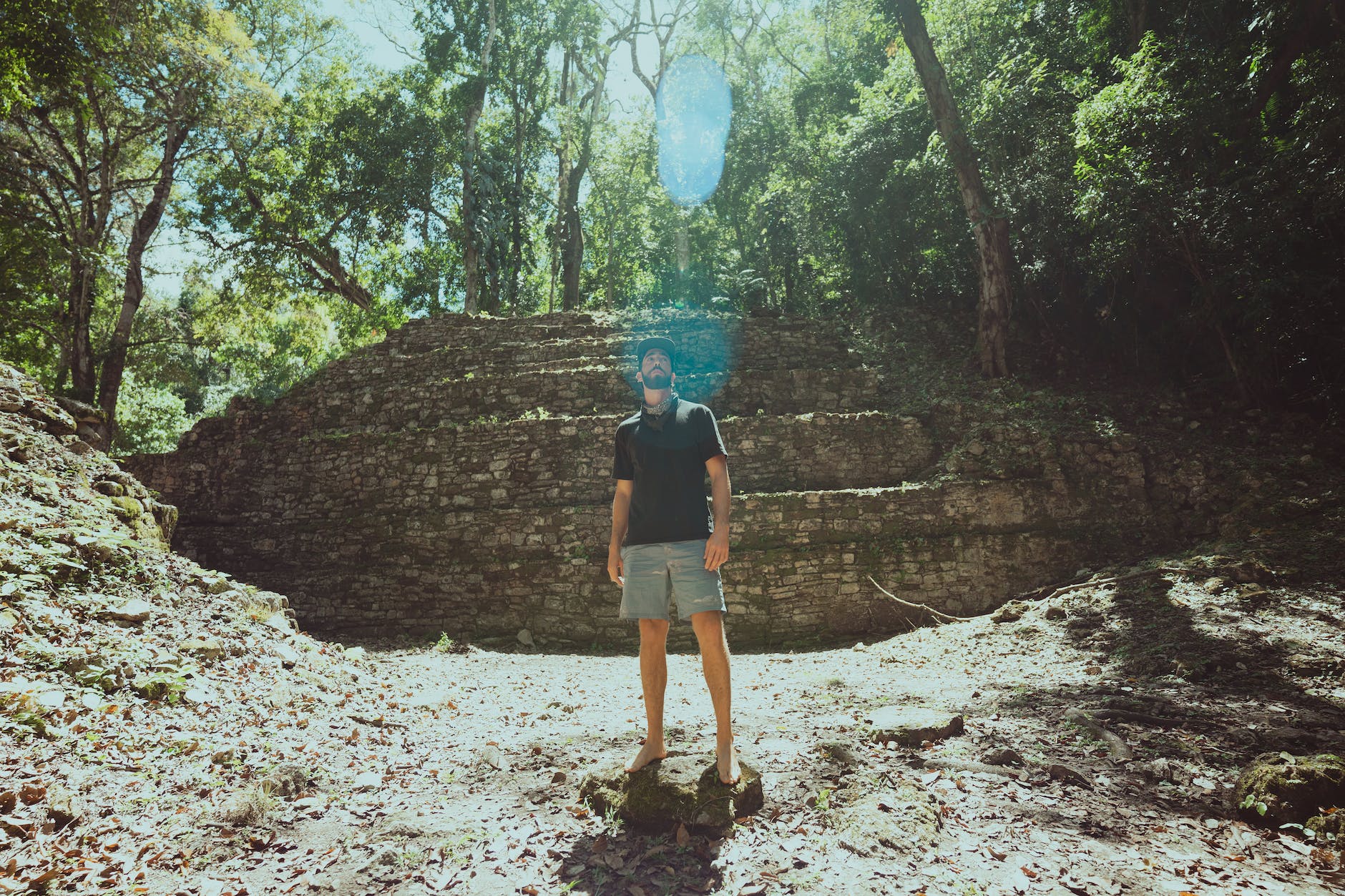 photo of a man standing on a rock